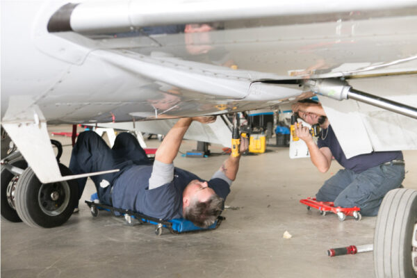 Maintenance Team Working Under Learjet