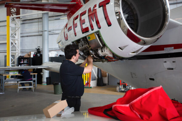 Maintenance Team Working on Learjet Exterior