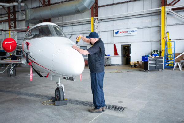 Maintenance Team Working on Learjet front